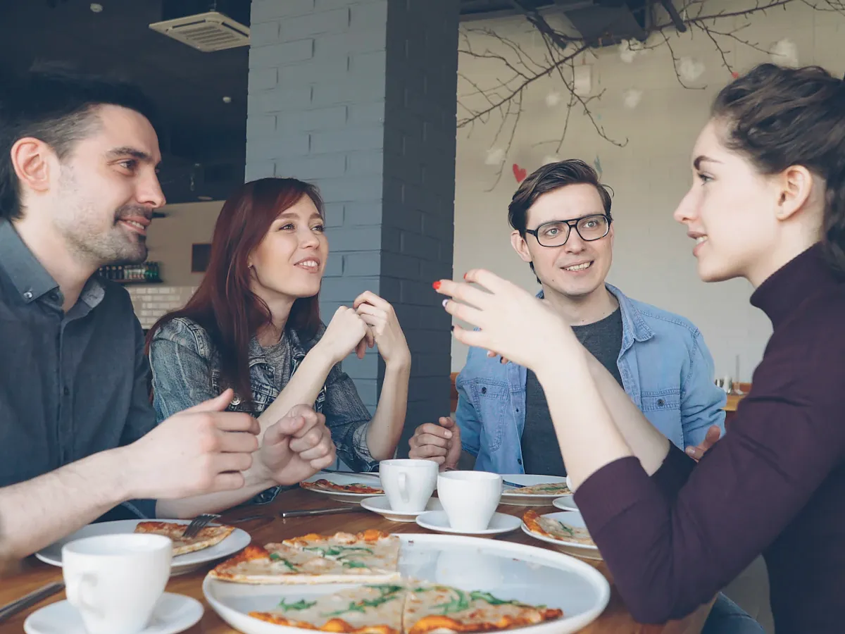 Friends laughing together over coffee