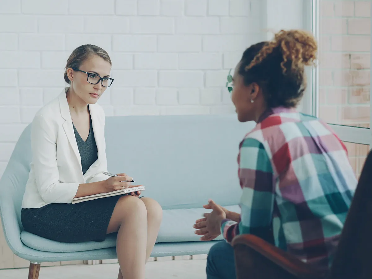 Therapist listening to a young woman during a counseling session