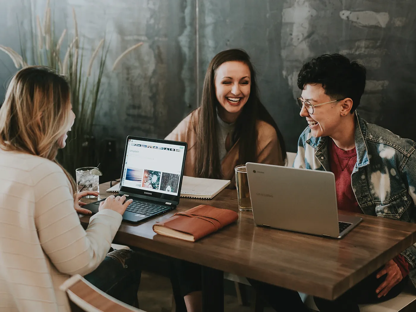 Coworkers laughing together around a table